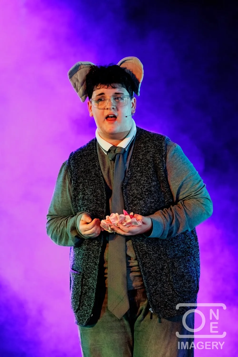 A performer playing Horton under purple stage lighting